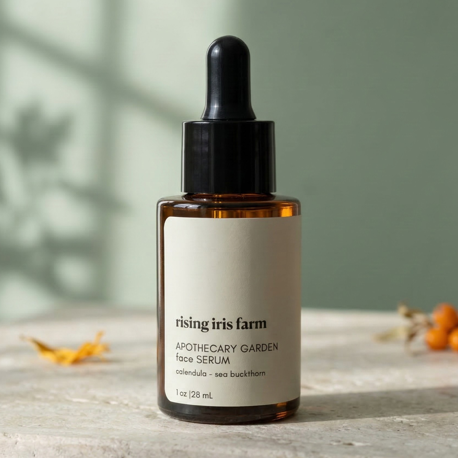 Bottle of 'rising iris farm' apothecary garden face serum on a wooden surface with a blurred green background.