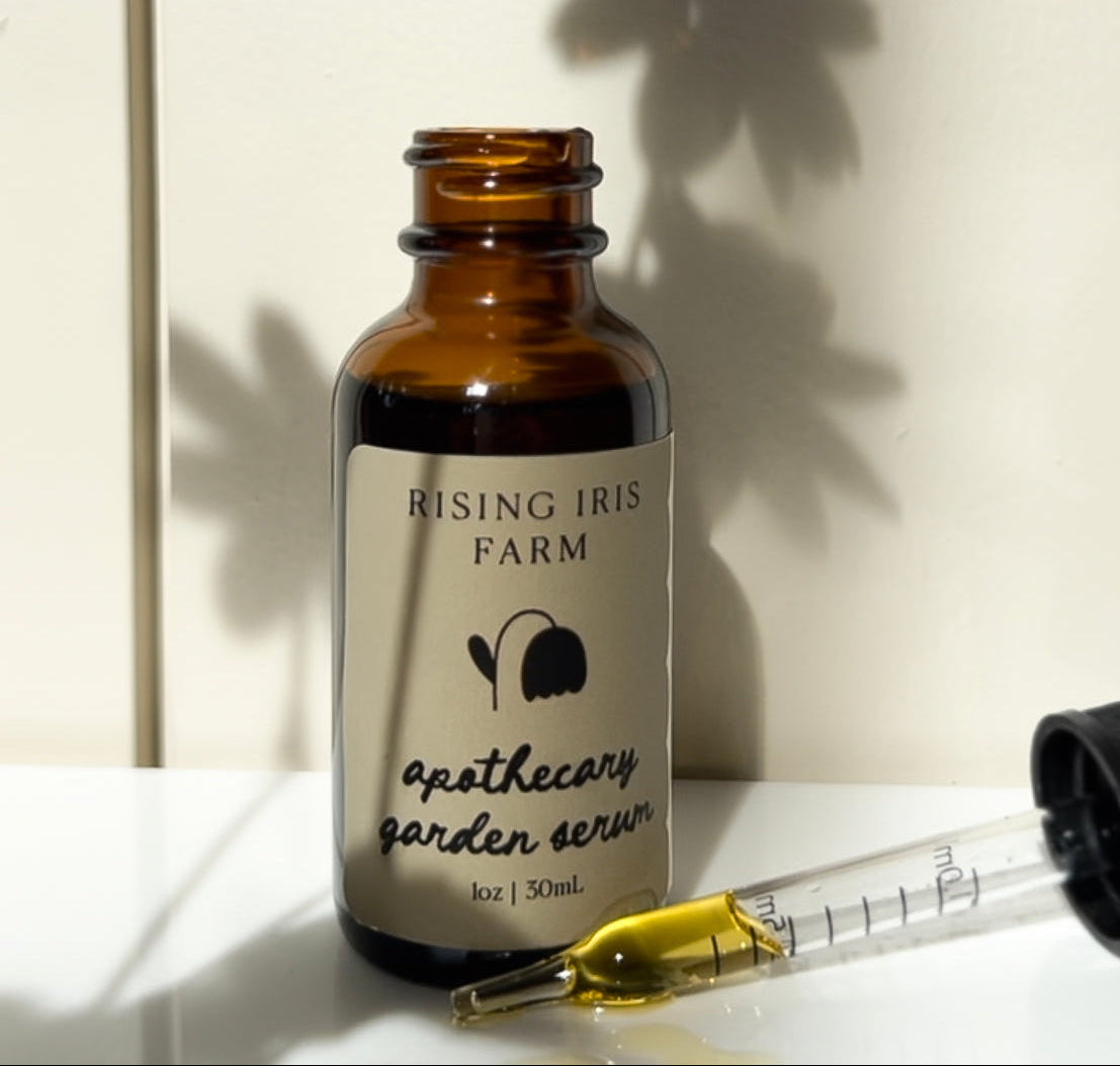 Close-up of serum dropper with botanical oil at Rising Iris Farm